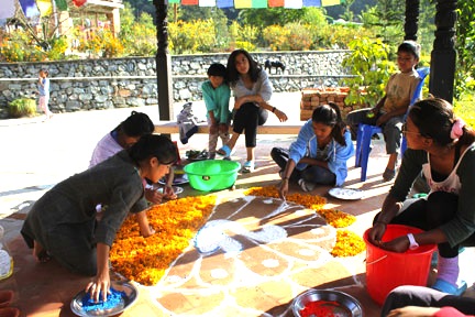 Everyone helps to make the mandalas for Mha Puja.