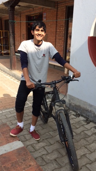 Mangel at Ama Ghar with his new bike.