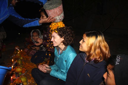 Jacole receives a shower of marigold petals as a Mha Puja blessing.
