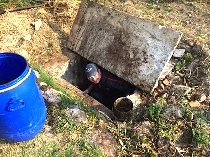 Tan Bahadur manages to look cheerful while fixing our septic system.