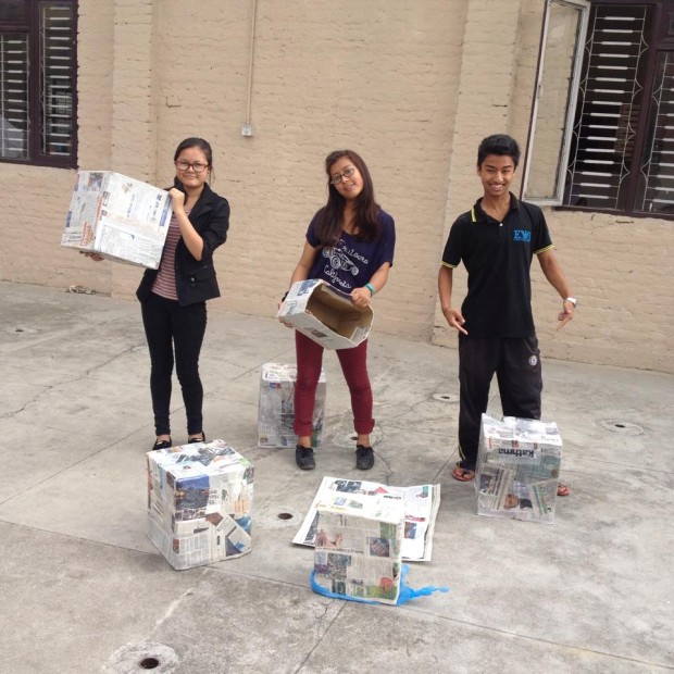 Sharmila (center) and her friends at Edulift created recycling collection boxes out of newspaper.