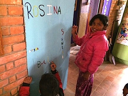 Sunita proudly adds her name to the Signature Wall