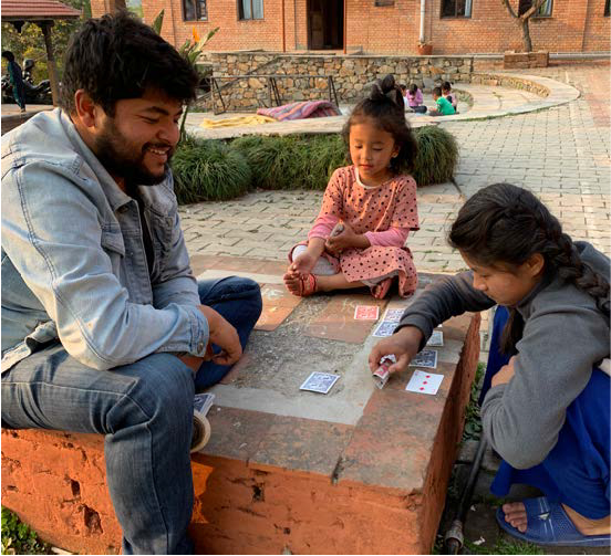 teacher with kids at ama ghar