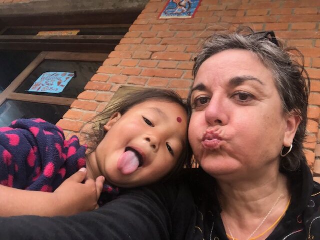 A woman and a young girl make funny faces.